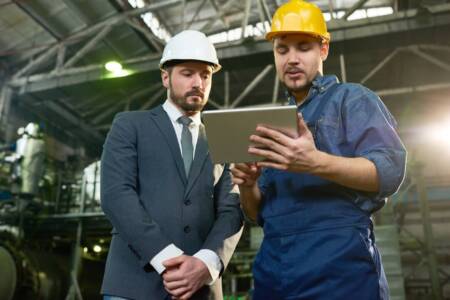 Worker Presenting Project to Businessman